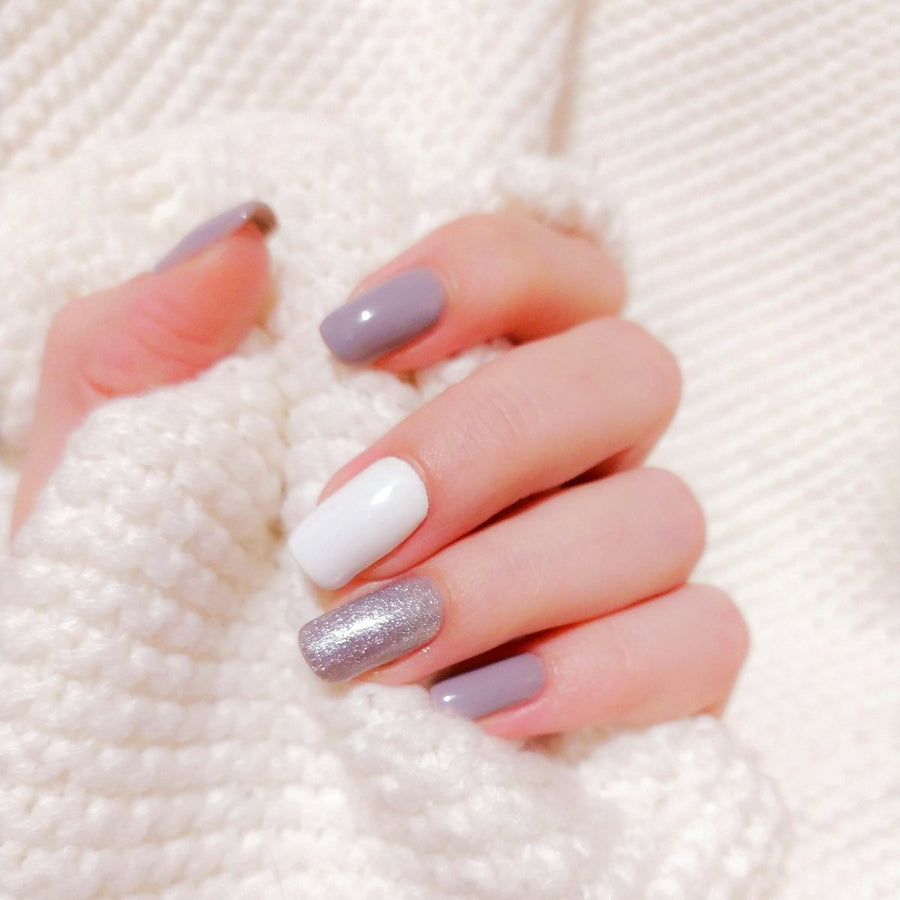 Festive glam nail art with gold glitter and jewel tones